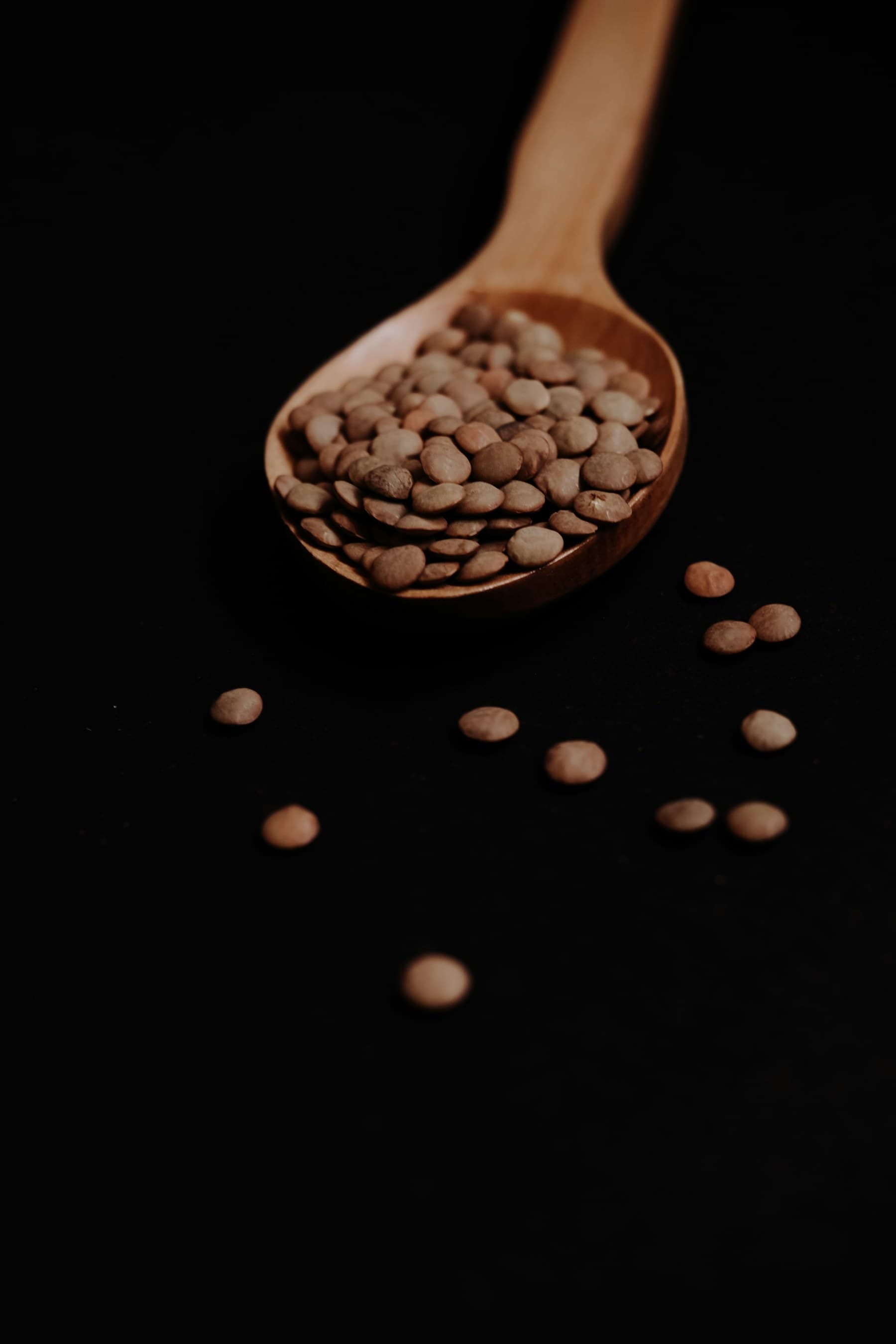 A bowl of dried beans on a dark surface